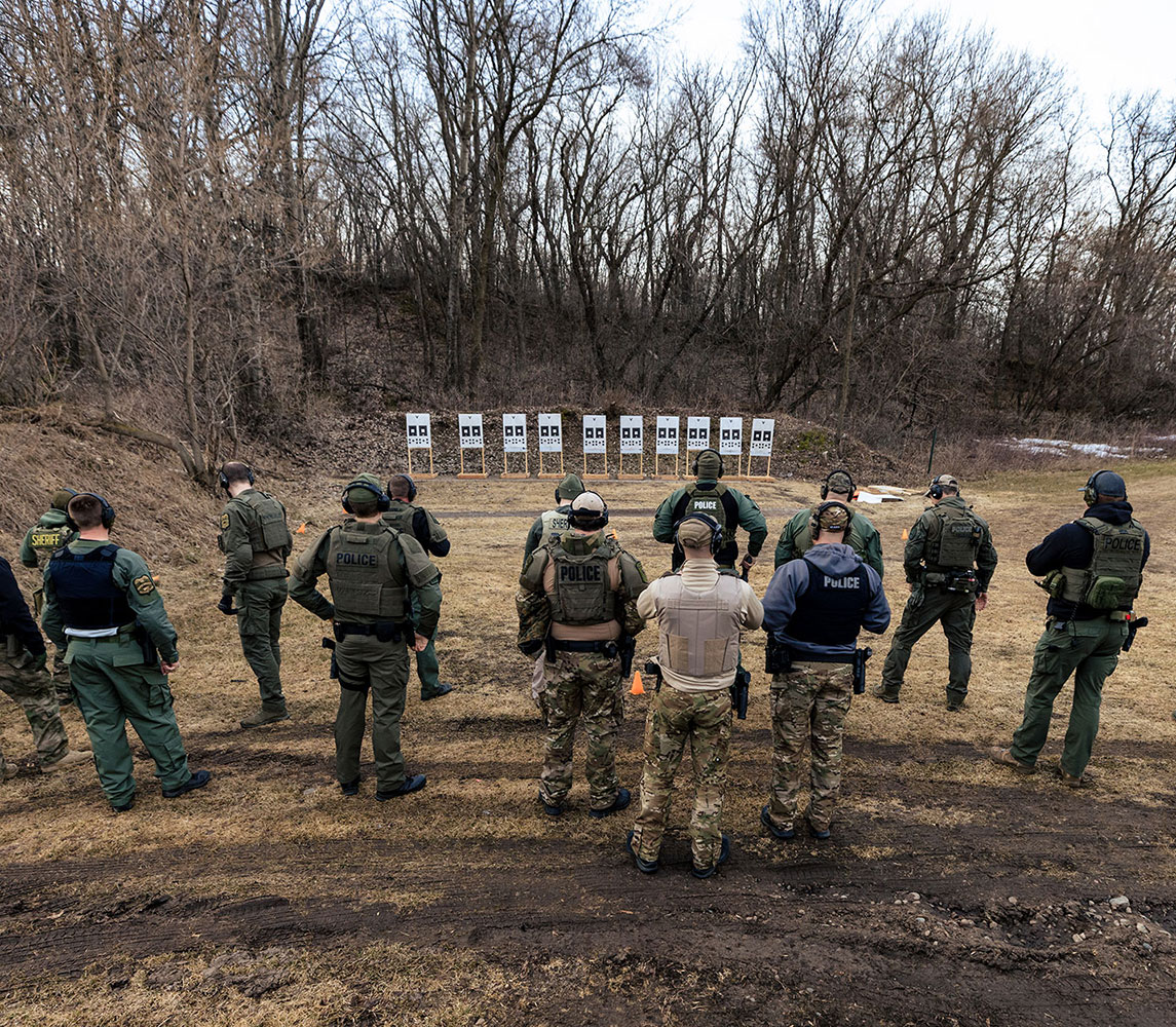 officers lined up in front of targets in rds training course